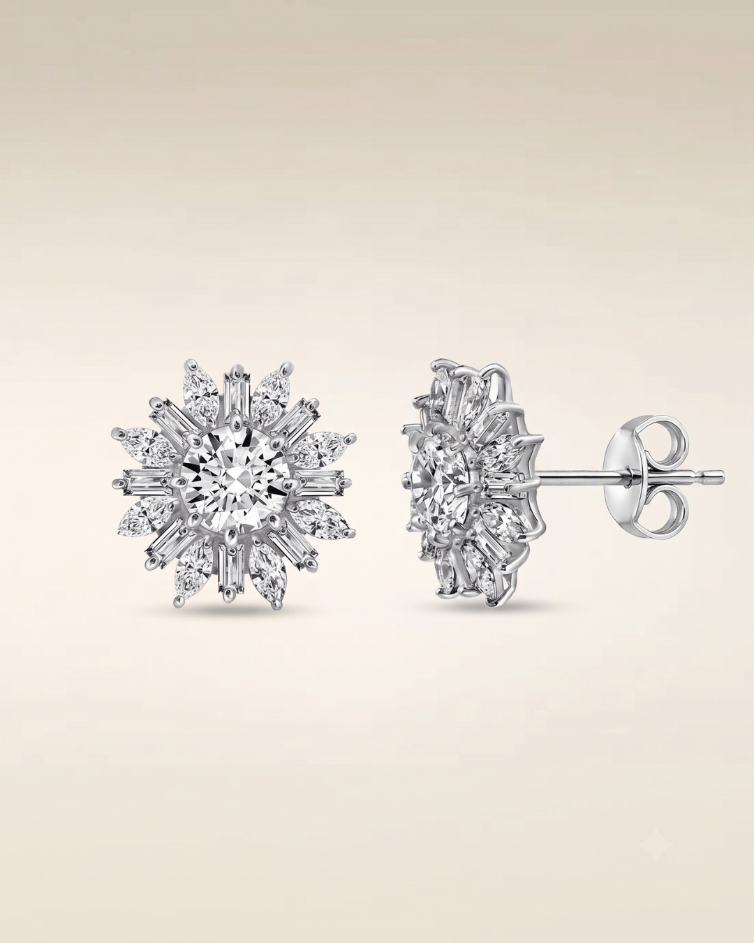 Three silver-toned floral cluster stud earrings paved with clear stones, arranged on a draped beige fabric surface with soft shadows.